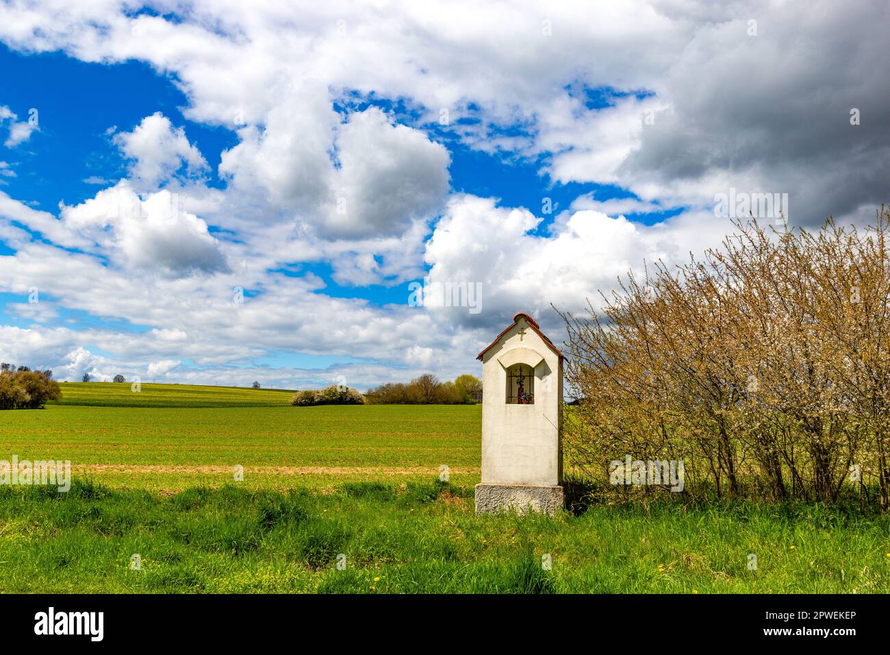 Small chapel in springtime field. Stock Photo