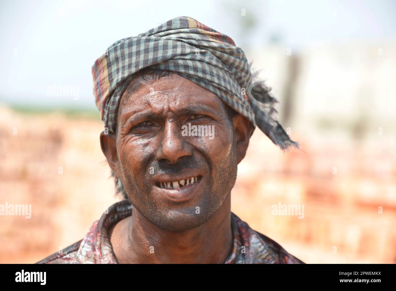 Dhaka, Bangladesh April 30, 2023 Bangladeshi worker carries bricks