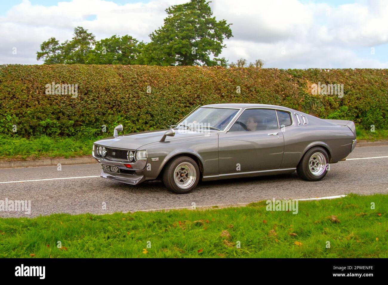 1975,70s seventies Toyota Celica Gt 2.0 Grey Car Petrol 1960 cc; Isolated classic car travelling on a country lane in Congleton, UK Stock Photo