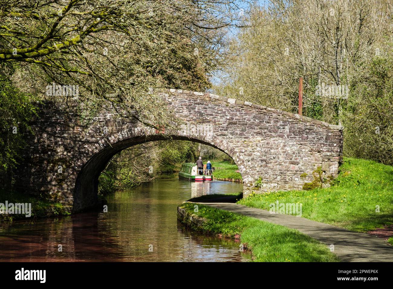 A narrowboat seen through old bridge 151 on Monmouthshire and Brecon Canal in Brecon Beacons National Park. Pencelli Brecon  Powys Wales UK Britain Stock Photo