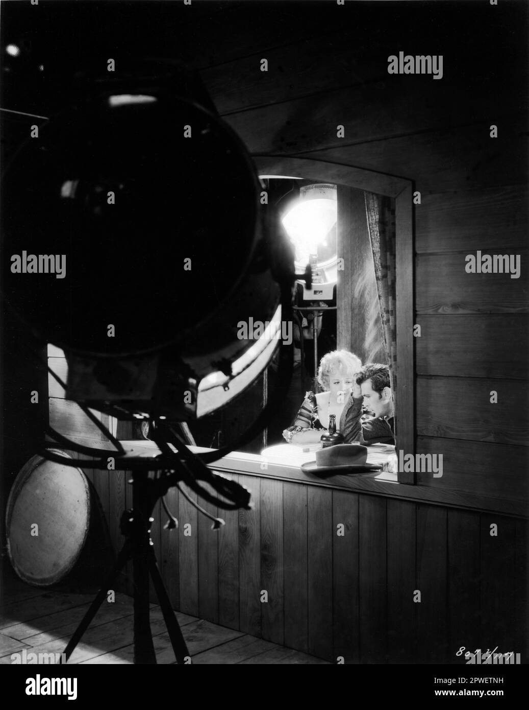 An on-set candid photograph of BETTY COMPSON and GARY COOPER taken during the making of THE SPOILERS 1930 Director EDWIN CAREWE Book REX BEACH Photograph by EARL CROWLEY  Paramount Pictures Stock Photo