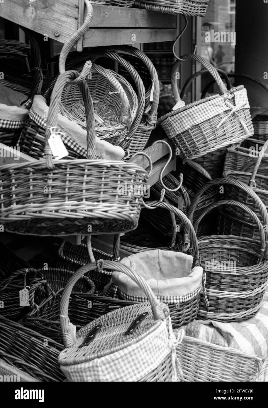 Black and white image of basket collection for sale at a market stall