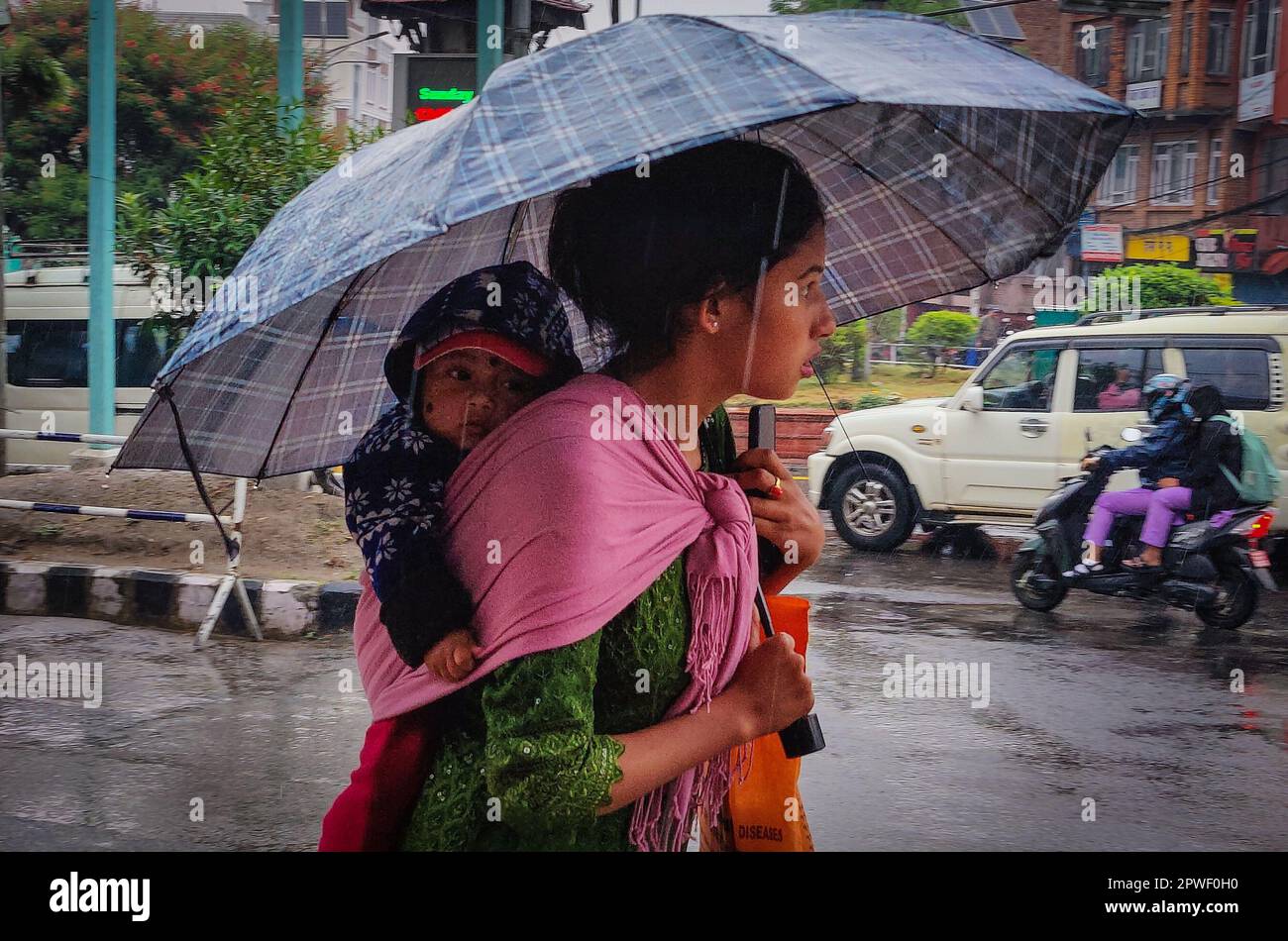 Kathmandu, Bagmati, Nepal. 30th Apr, 2023. A woman carries her baby
