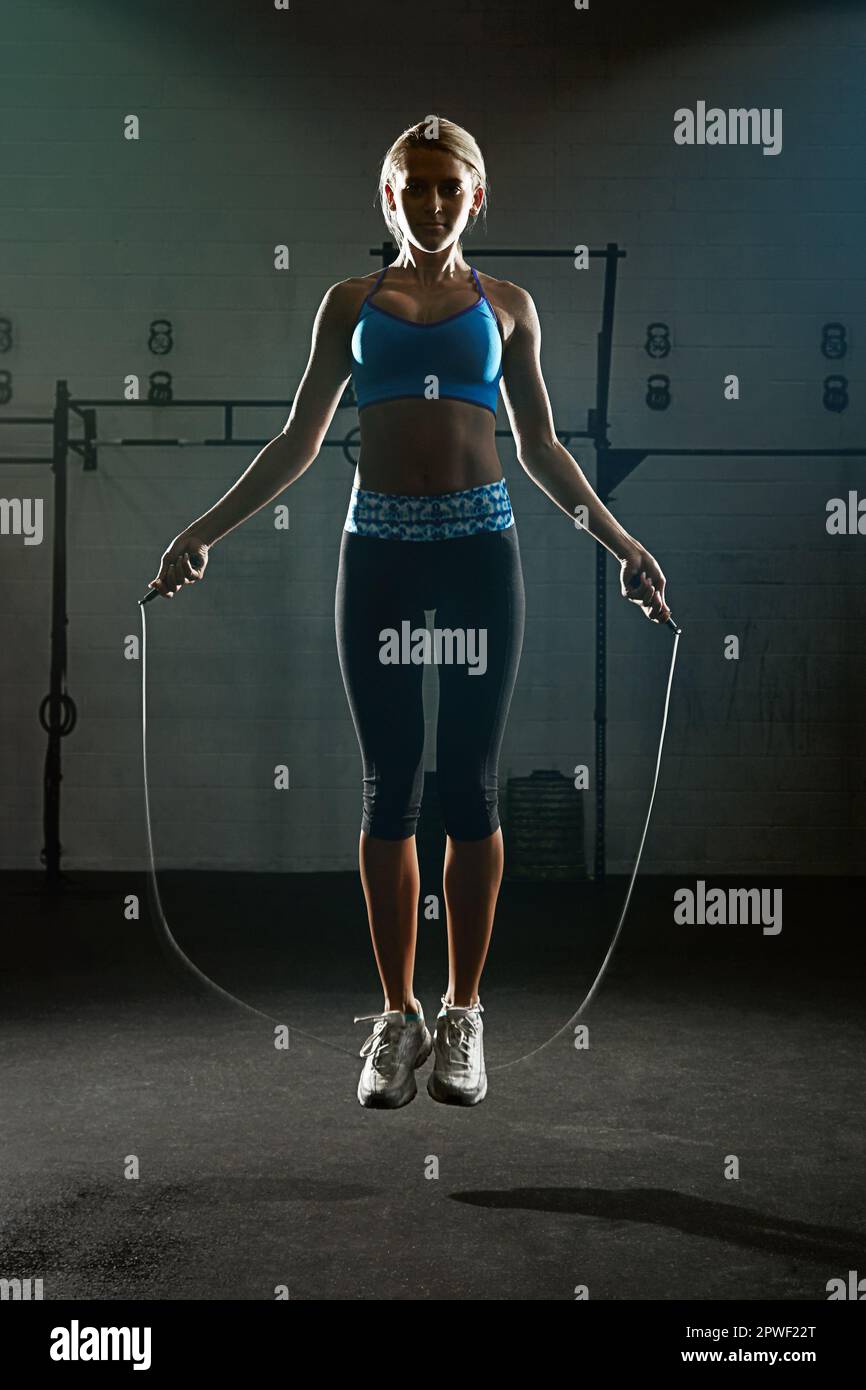 Jump Rope Action Photo Take action, just jump. a young woman jumping rope in a gym Stock Photo ...