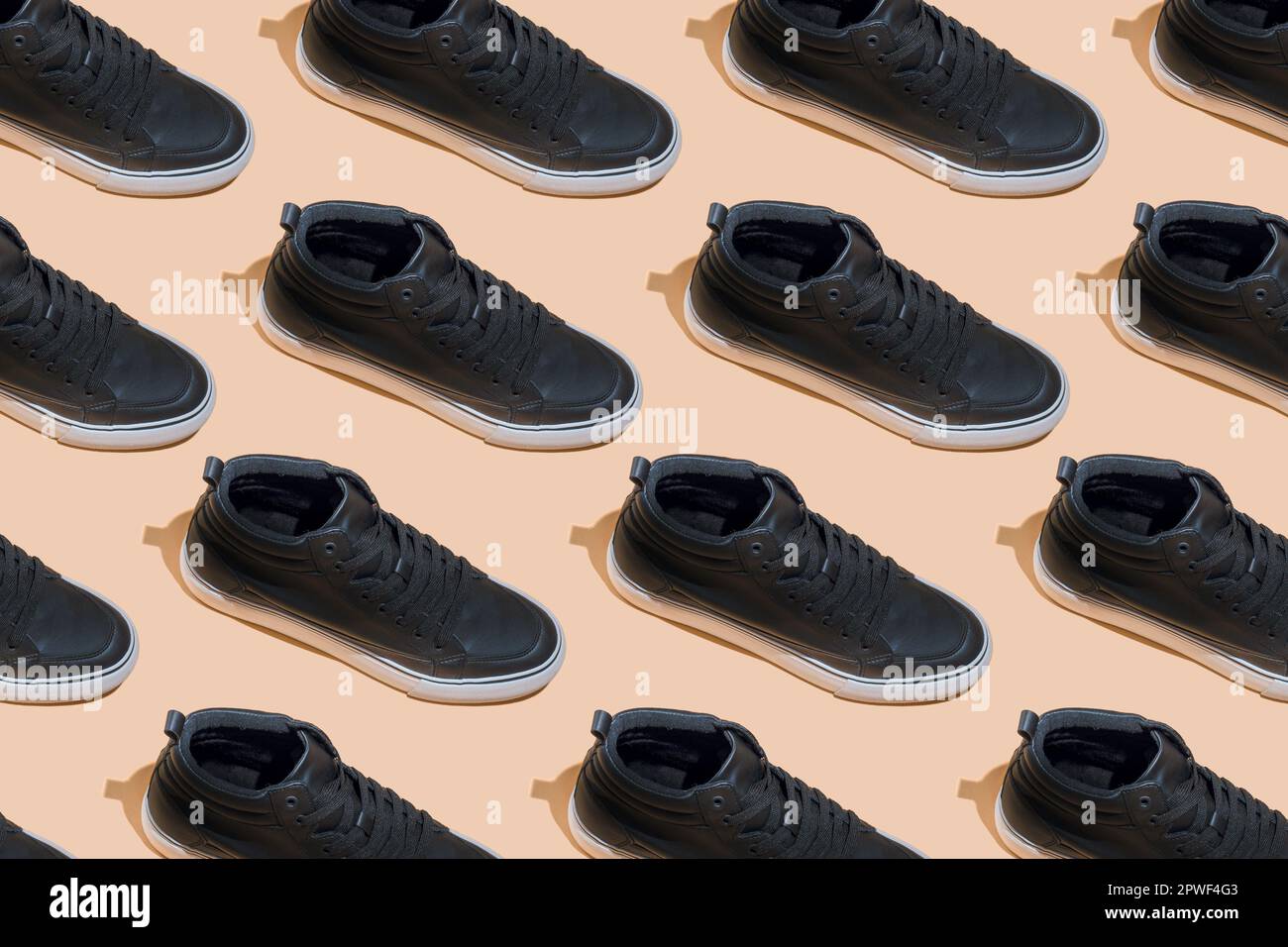 Shoe pattern. Black shoes on a beige pastel background top view with ...