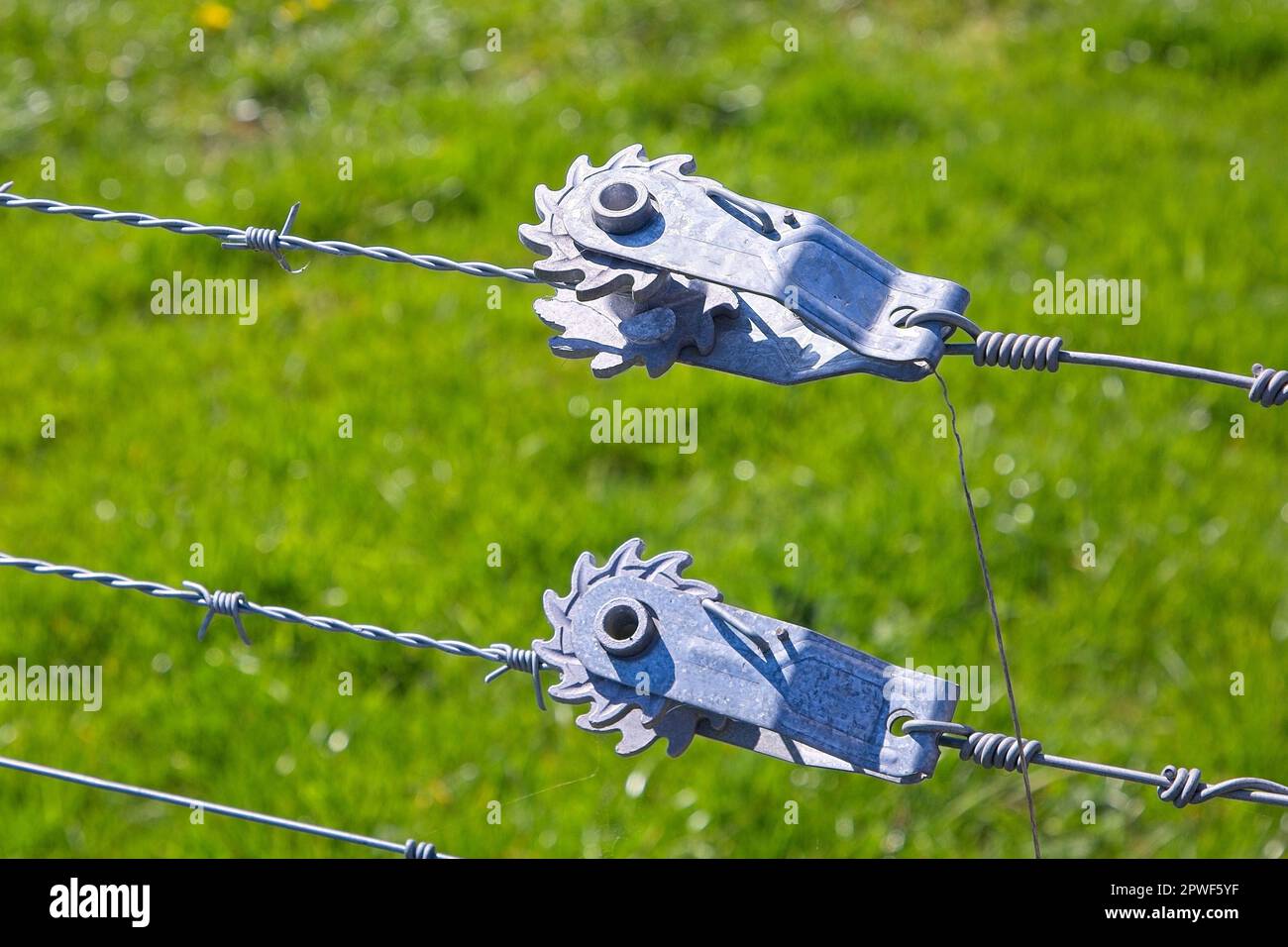 Close up on a pair of wire tensioners holding wire tight Stock Photo