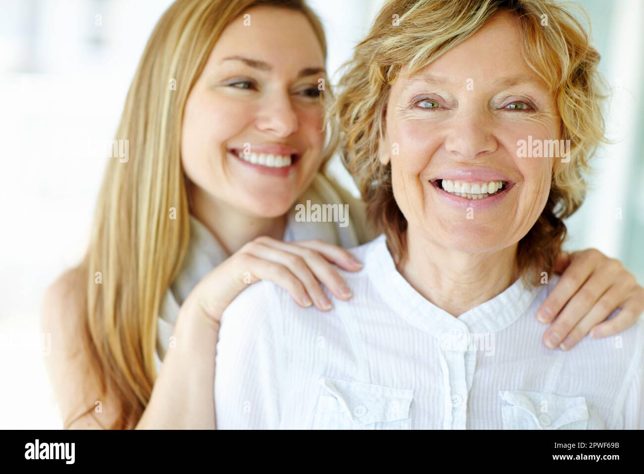 Affectionate rub of the shoulders. A beautiful mature woman giving her mother an affectionate shoulder rub. Stock Photo