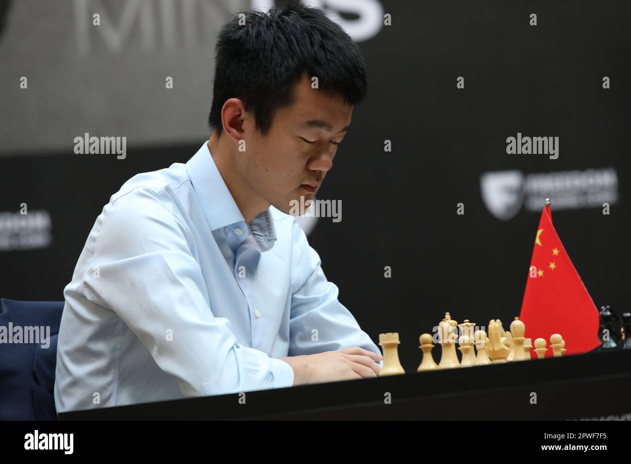 China's Ding Liren, left, and Russia's Ian Nepomniachtchi shake hands prior  to their FIDE World Chess Championship in Astana, Kazakhstan, Saturday,  April 29, 2023. Ian Nepomniachtchi and Ding Liren are facing off