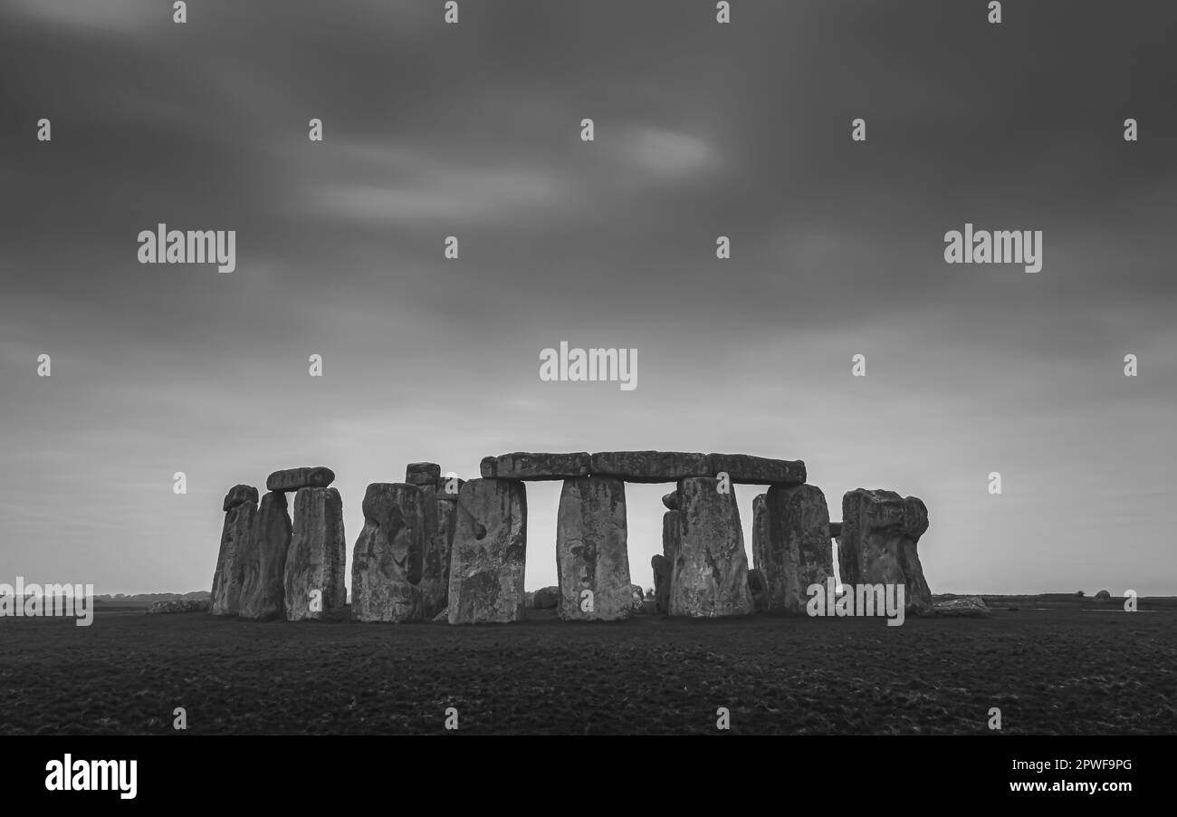 A moody black and white image of the iconic prehistoric neolithic standing stone circle Stonehenge, a pagan site of ritual dating back to the Bronze A Stock Photo