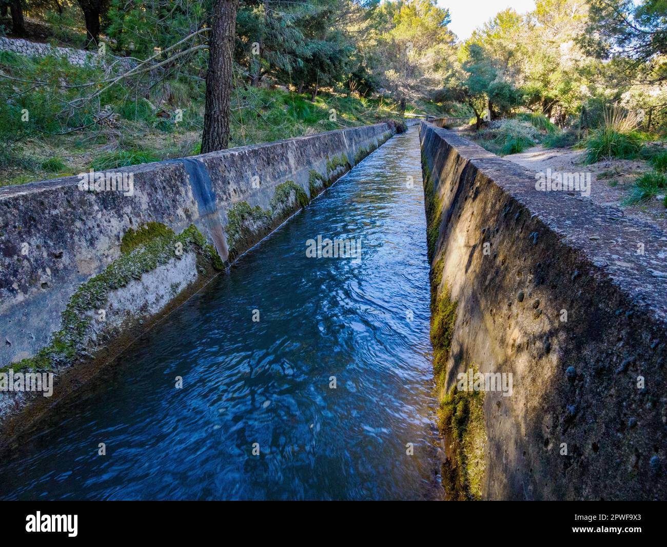 The Canal des Embassaments a concrete channel feeding water into the Cuber and Gorg Blau reservoirs in Tramuntana Mountains of Majorca Spain Stock Photo