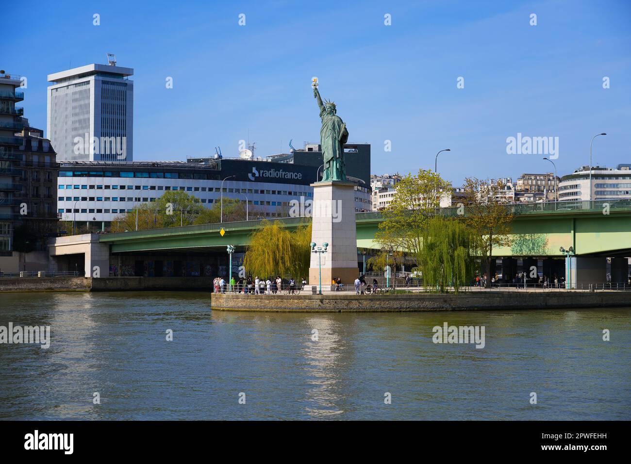 Paris, France - April 9, 2023 : Statue of Liberty by the Grenelle Bridge in the center of the Seine river in Paris, France - Facing west, this copper Stock Photo