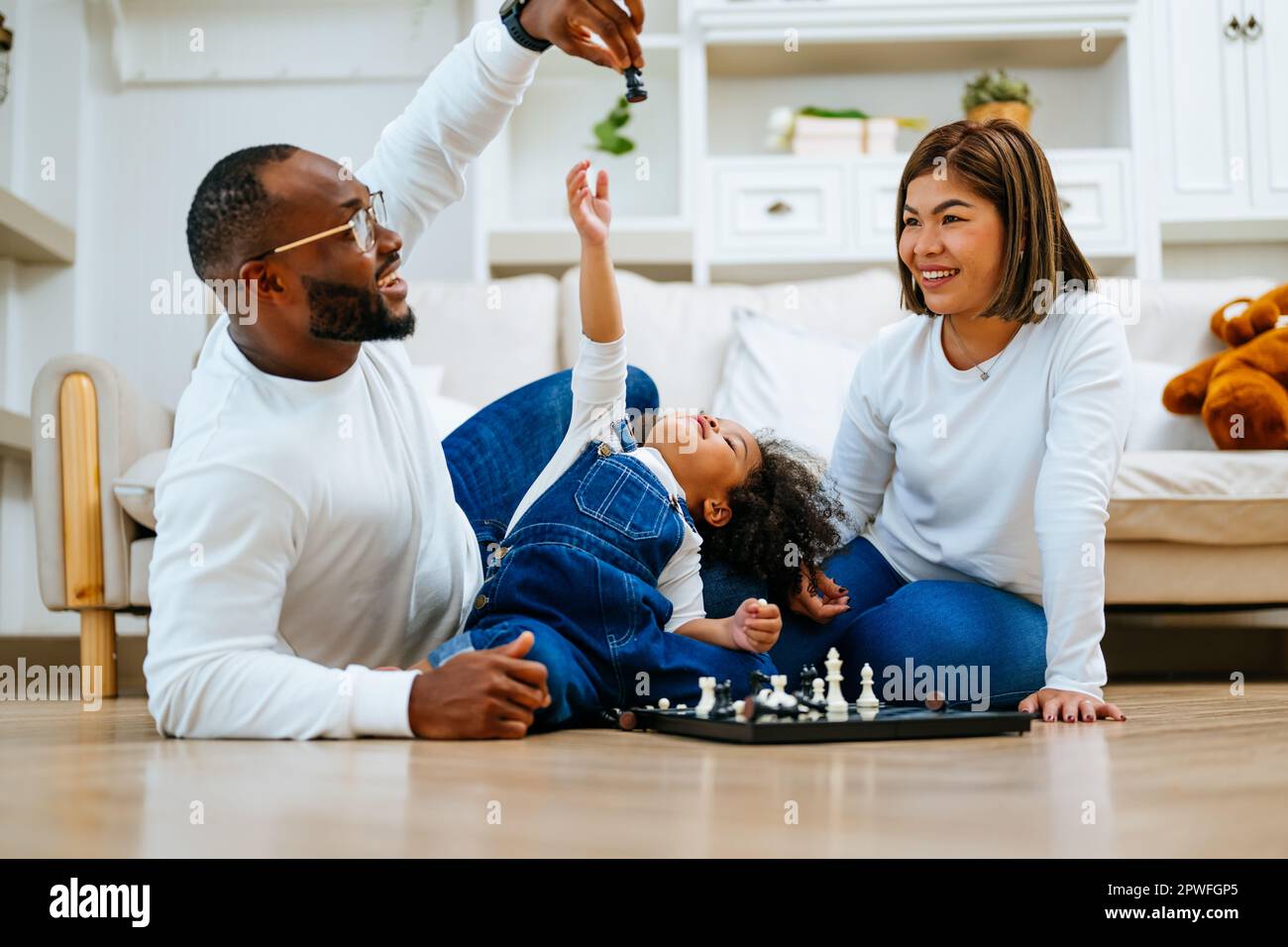 Happy family spending time and having activities together at home Stock Photo