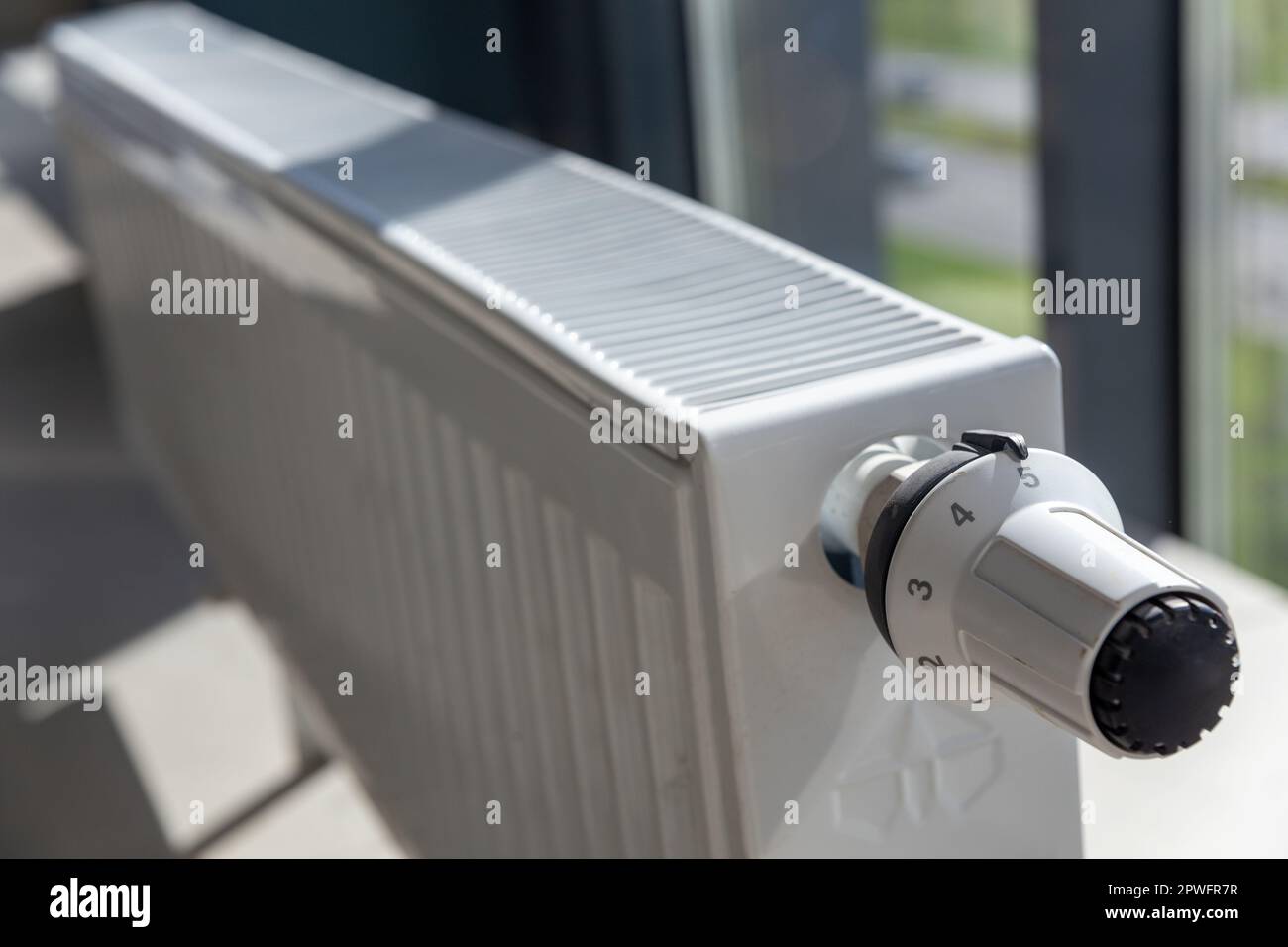Close-up of white central heating floor radiator with a power regulator in the maximum position. Stock Photo