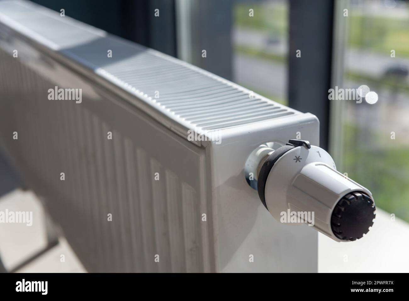 Close-up of white central heating floor radiator with a power regulator in the minimum position. Stock Photo