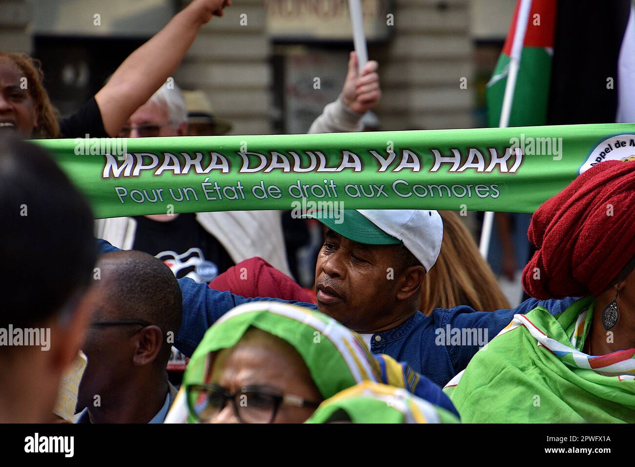 Marseille, France. 29th Apr, 2023. A protester holds a banner during the demonstration. Several people mostly the Comorian population, demonstrated in Marseille against the immigration law by the French government of Emmanuel Macron and supported by the Minister of Interior Gérald Darmanin, and against the 'Wuambushu' security operation in Mayotte. (Photo by Gerard Bottino/SOPA Images/Sipa USA) Credit: Sipa USA/Alamy Live News Stock Photo