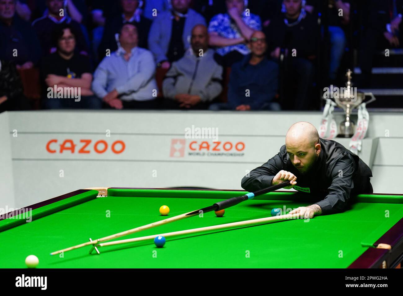 Luca Brecel in action against Mark Selby (not pictured) during the final on day sixteen of the Cazoo World Snooker Championship at the Crucible Theatre, Sheffield