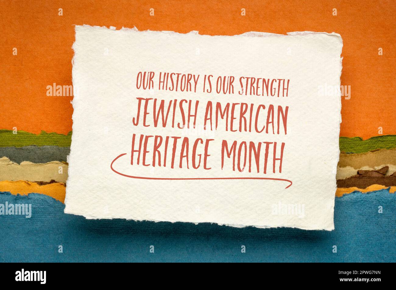 Our history is our strength - Jewish American Heritage Month - handwriting on a sheet of watercolor paper against abstract landscape, reminder of cult Stock Photo