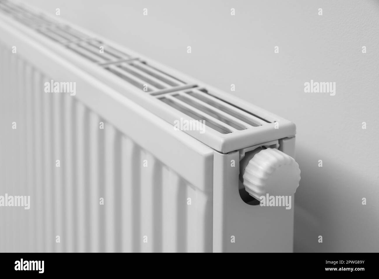 Modern radiator on white wall, closeup. Central heating system Stock ...