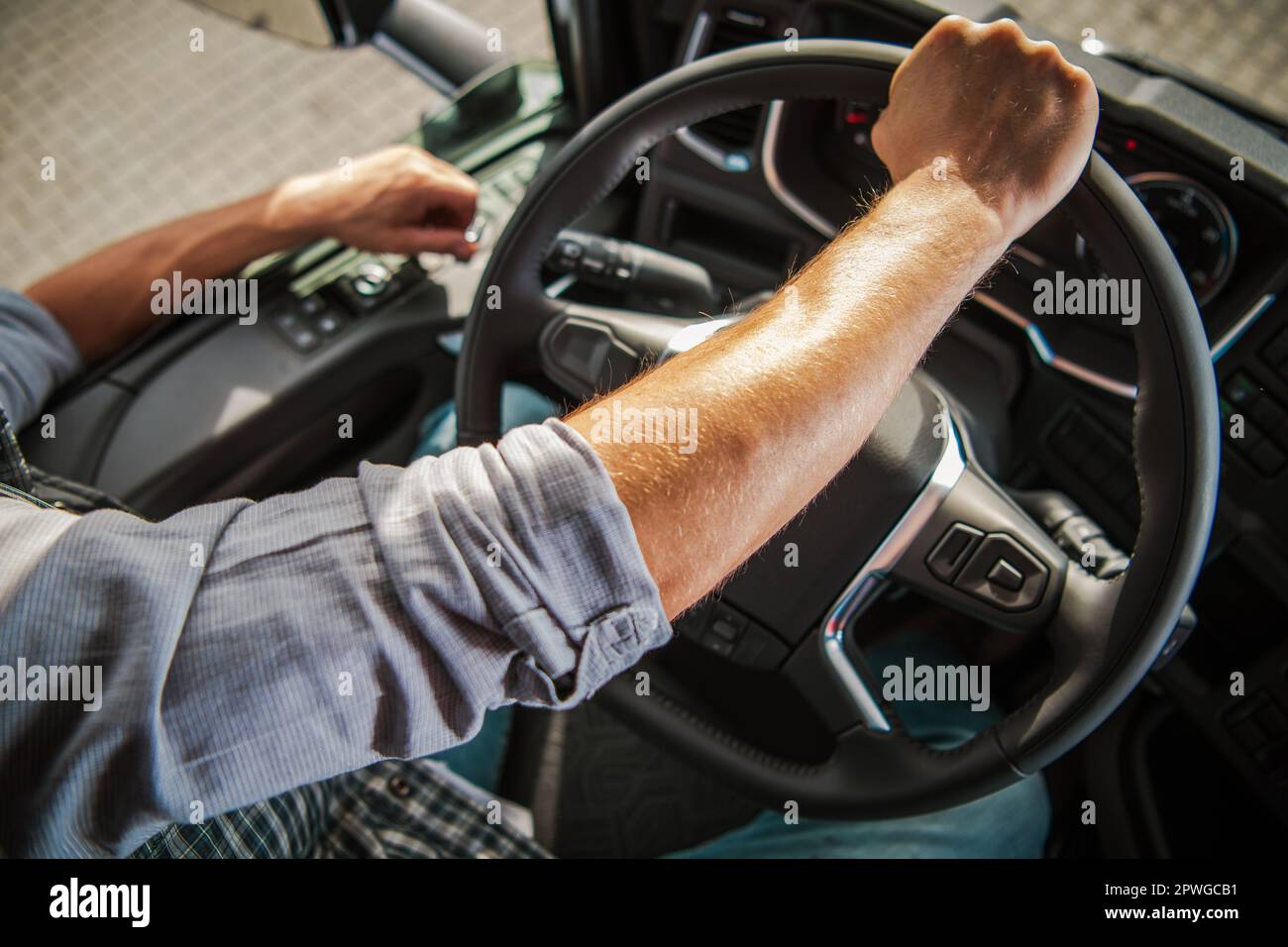 https://c8.alamy.com/comp/2PWGCB1/truckers-hand-on-a-semi-truck-steering-wheel-close-up-photo-caucasian-professional-driver-theme-transportation-industry-2PWGCB1.jpg