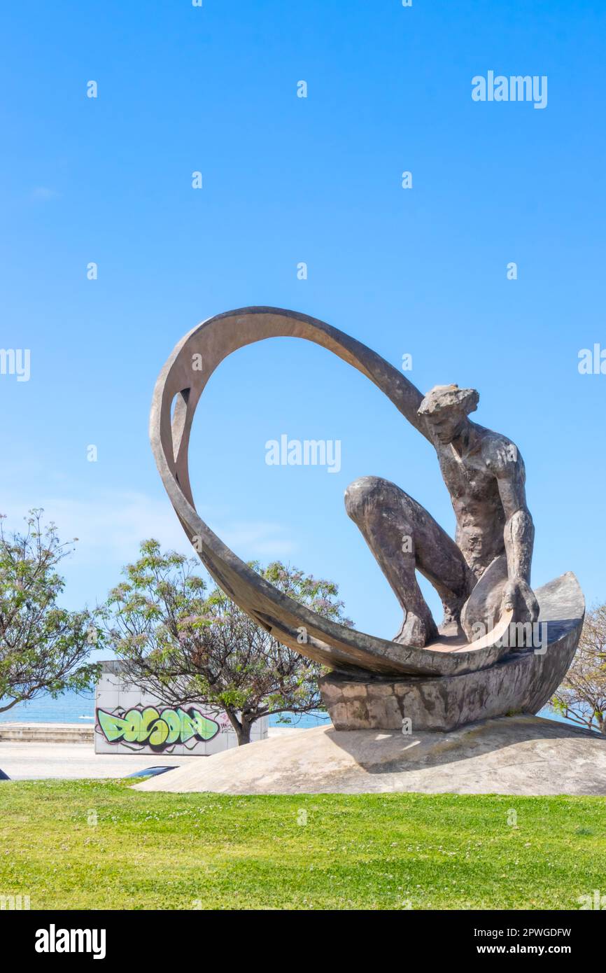Rotunda dos Pescadores Sculpture of a man sitting in an abstract boat-shaped structure, located in a coastal areaalbufeira portugal Stock Photo