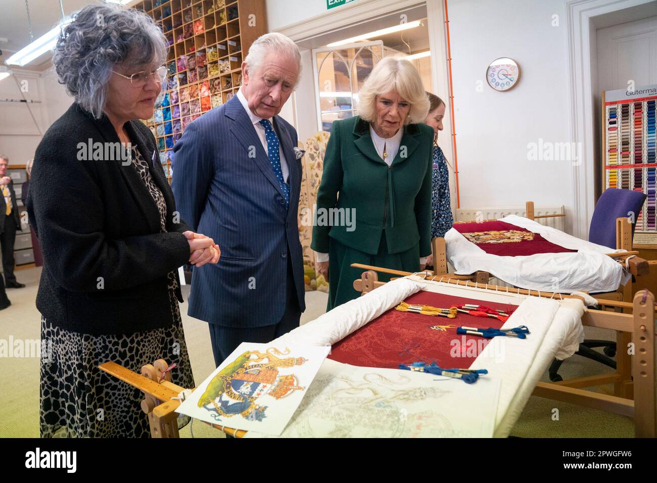 King Charles III and the Queen Consort look at their throne seat covers