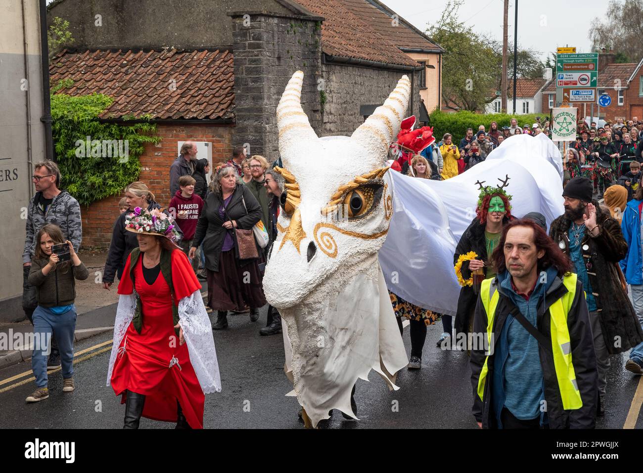 Glastonbury, UK. 30th April, 2023. Glastonbury’s streets packed with spectators as the Glastonbury Dragons make their way from the Abbey Abbots Kitchen Field and up the High Street towards the Fairfield. Credit: Stephen Bell/Alamy Live News Stock Photo