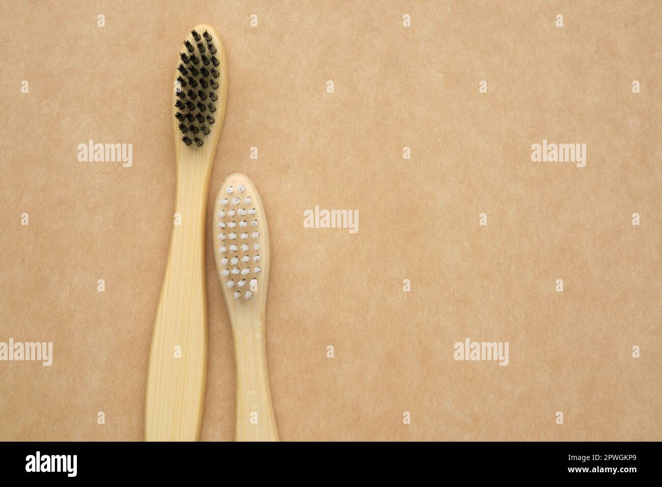 A pair of eco friendly wooden bamboo toothbrushes. Living together. Love concept. A conceptual of a couple toothbrushes in love. Stock Photo