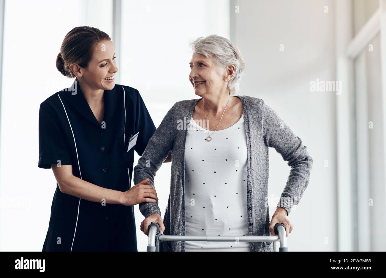 Shes all the care you need. a female nurse assisting a senior woman using a walker. Stock Photo