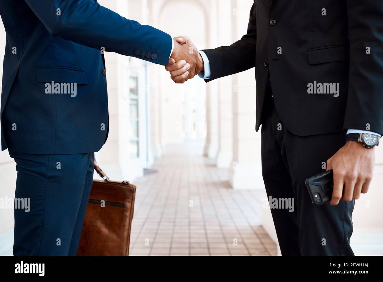 Expand the business by making partners. unrecognizable businessmen shaking hands outside. Stock Photo