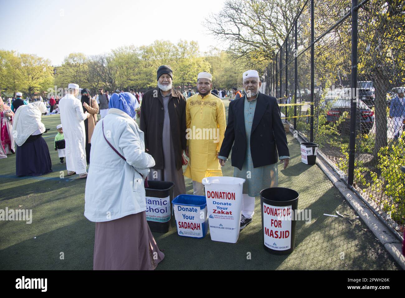 Muslims from various mosques in Brooklyn attend a prayer service on Eid at the end of Ramadan in Prospect Park, Brooklyn, New York.  Zakat is a charity God obligates Muslims to pay yearly on their money and property. Its payment is made to the poor, vulnerable, and deserving as their divinely established right. Stock Photo