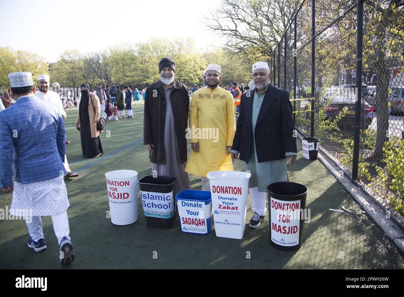 Muslims from various mosques in Brooklyn attend a prayer service on Eid at the end of Ramadan in Prospect Park, Brooklyn, New York.  Zakat is a charity God obligates Muslims to pay yearly on their money and property. Its payment is made to the poor, vulnerable, and deserving as their divinely established right. Stock Photo