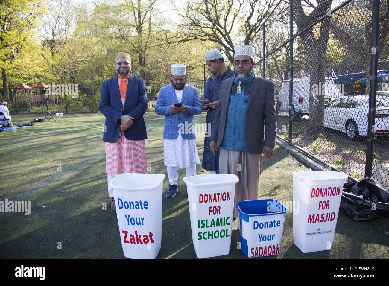Muslims from various mosques in Brooklyn attend a prayer service on Eid at the end of Ramadan in Prospect Park, Brooklyn, New York.  Zakat is a charity God obligates Muslims to pay yearly on their money and property. Its payment is made to the poor, vulnerable, and deserving as their divinely established right. Stock Photo