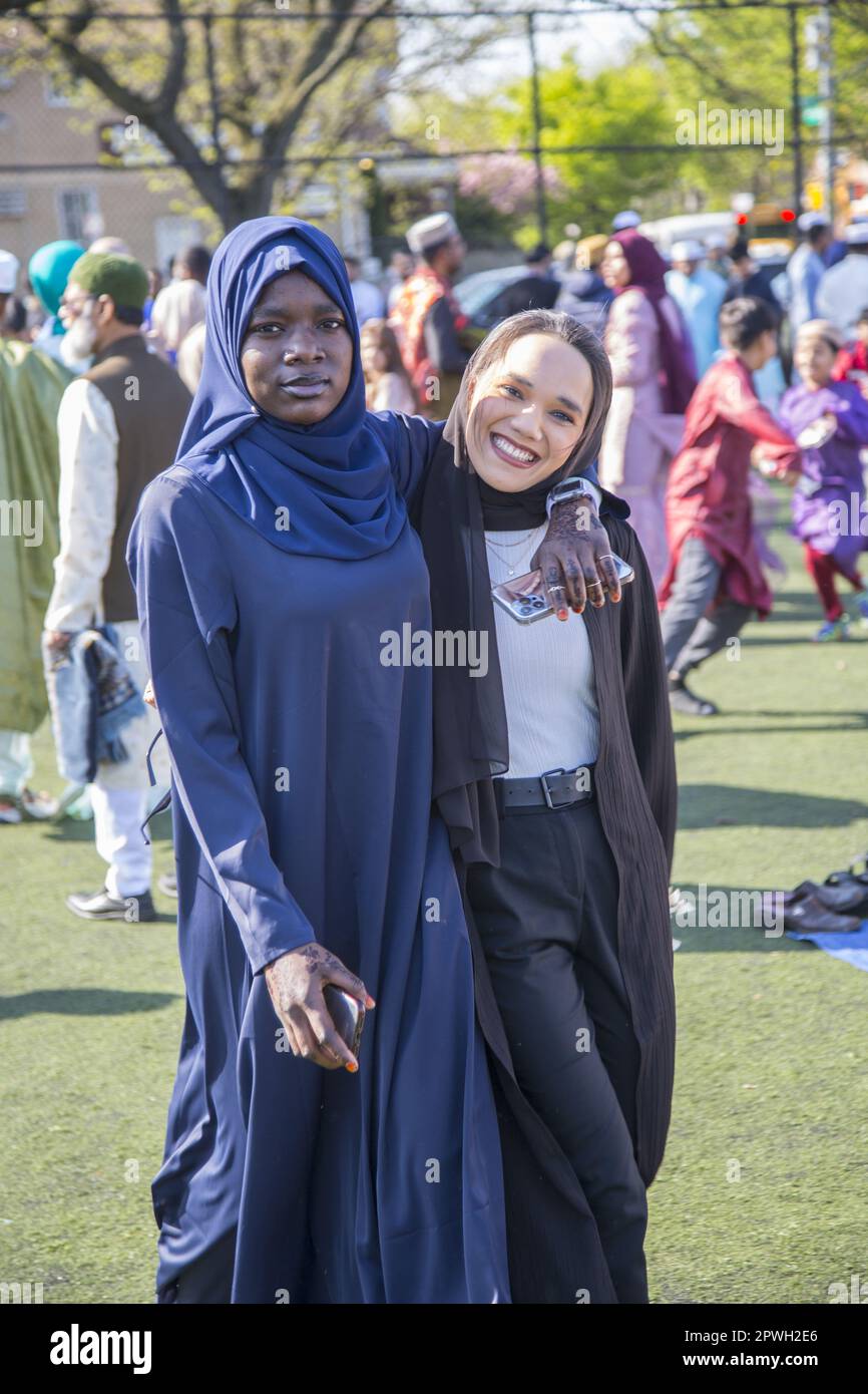 Muslims from various mosques in Brooklyn attend a prayer service on Eid at the end of Ramadan in Prospect Park, Brooklyn, New York.  Friends at the prayer service. Stock Photo