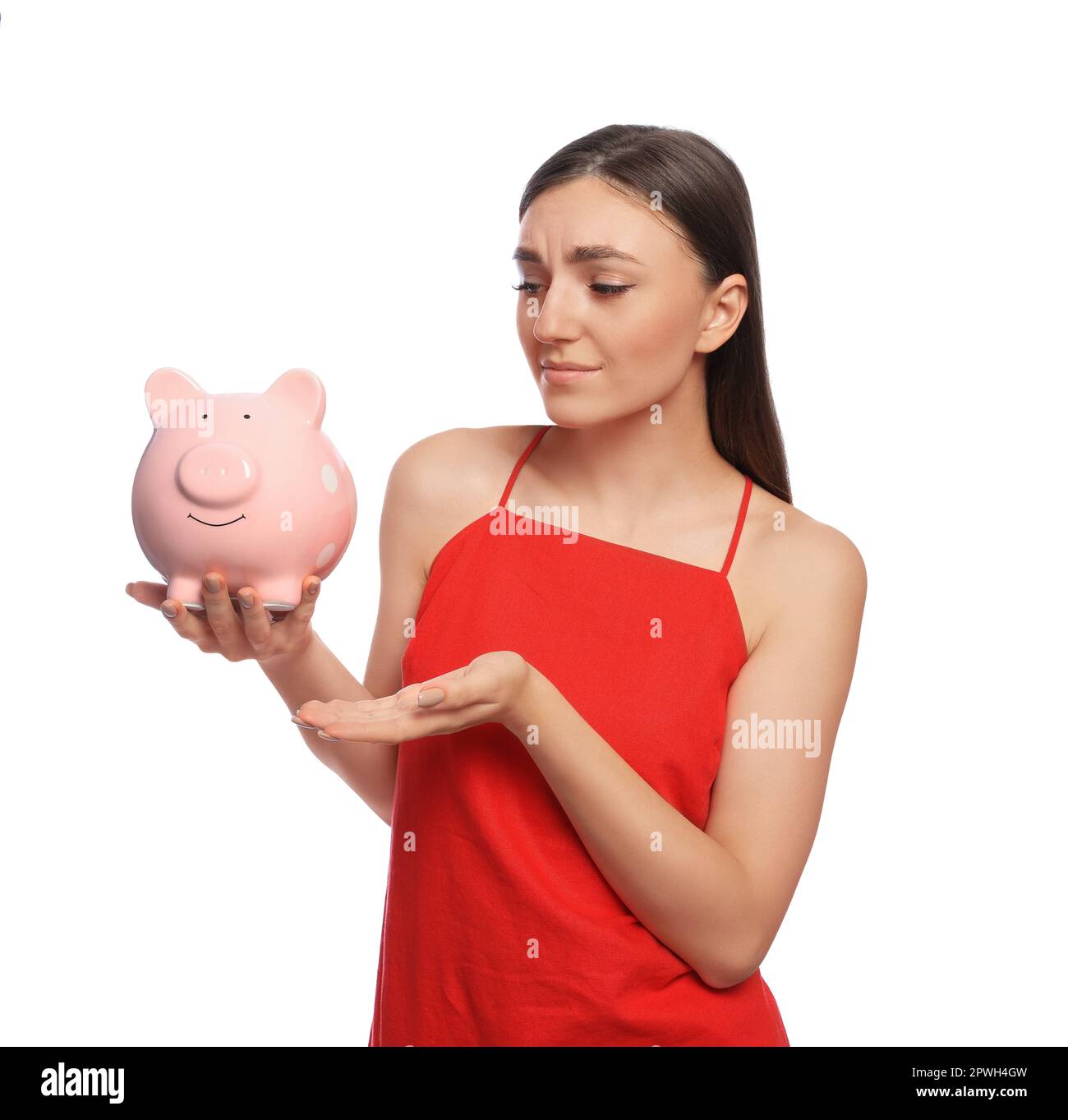 Sad young woman with piggy bank on white background Stock Photo - Alamy
