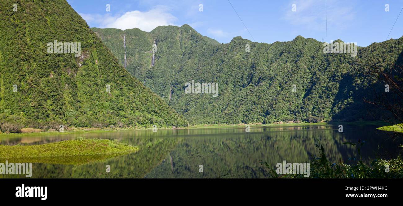 Panoramic view of Grand Étang (the biggest lake in Reunion Island the waterfall known as Cascades du Bras d'Annette. Stock Photo