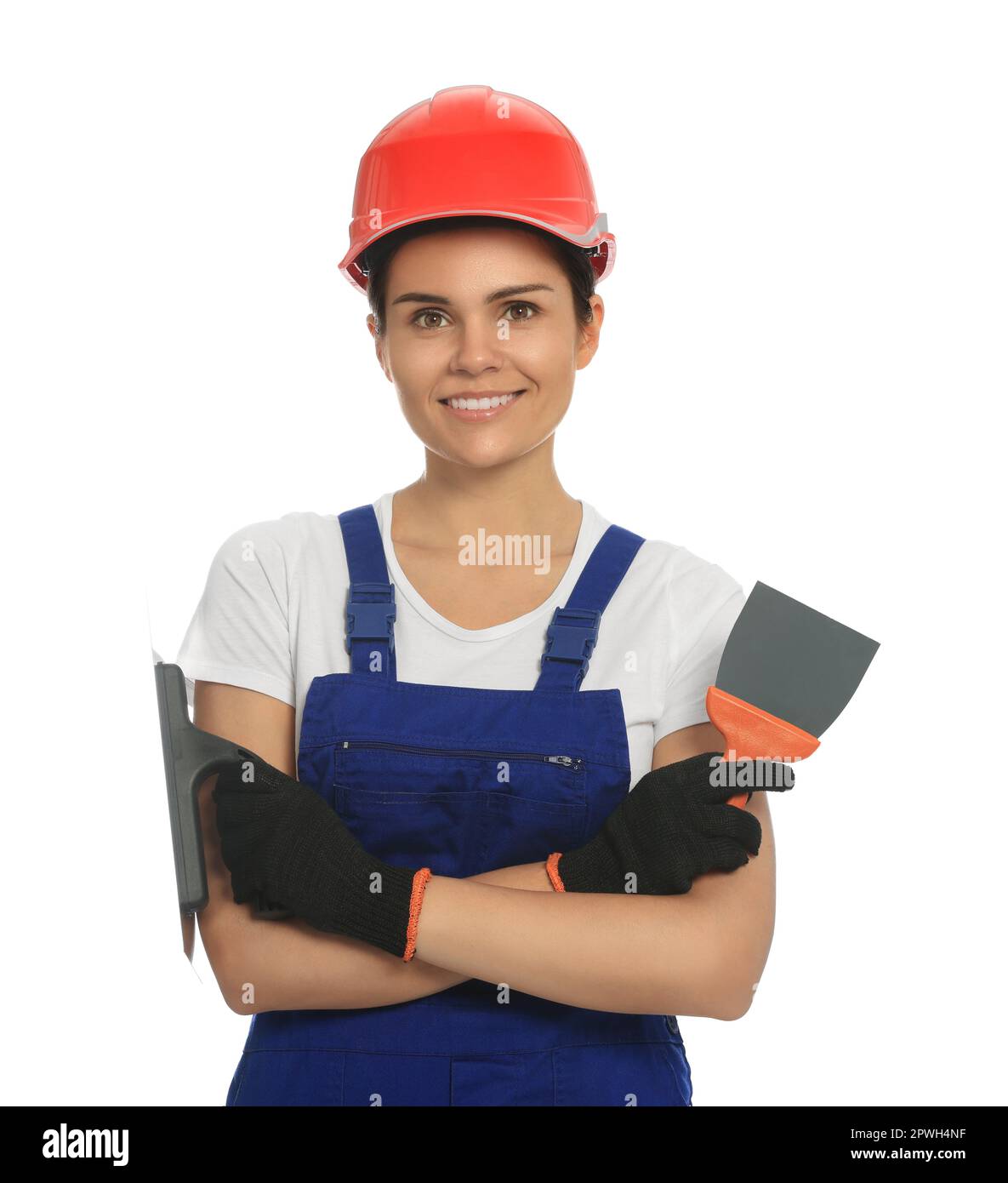 Professional worker with putty knives in hard hat on white background