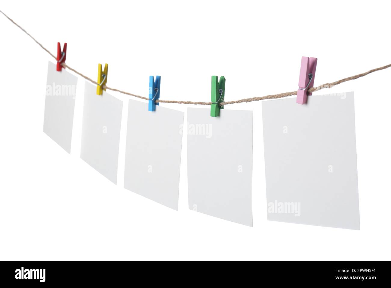 Clothespins with empty notepapers on string against white background. Space for text Stock Photo