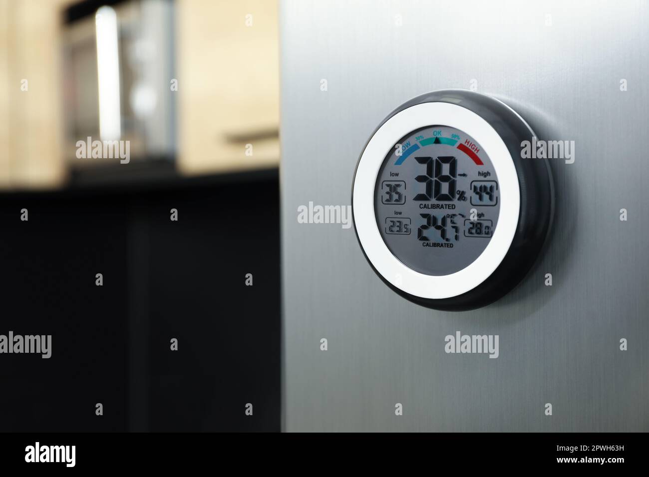 https://c8.alamy.com/comp/2PWH63H/round-digital-hygrometer-with-thermometer-on-fridge-in-kitchen-space-for-text-2PWH63H.jpg