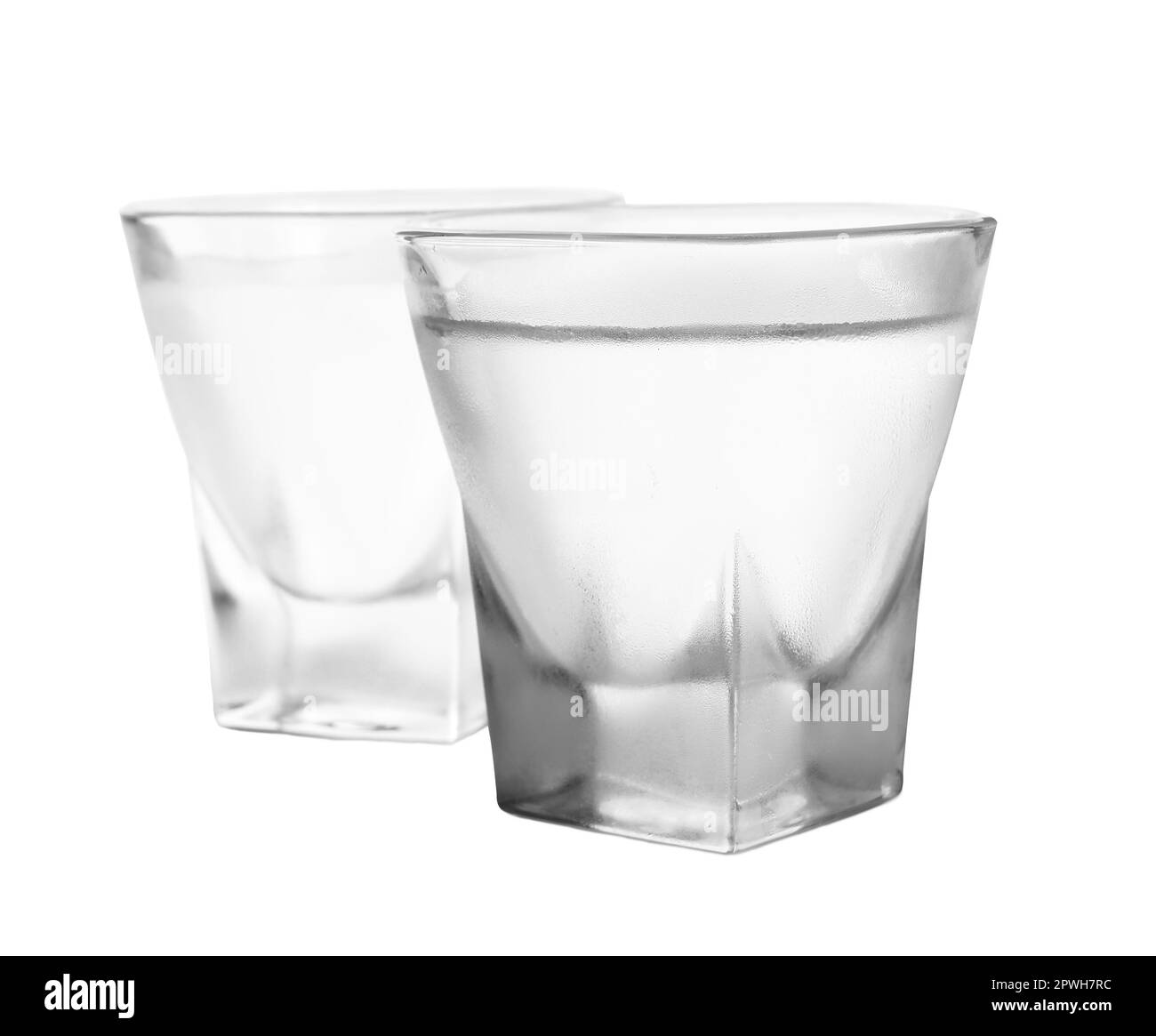 Vodka in shot glasses on white background Stock Photo - Alamy