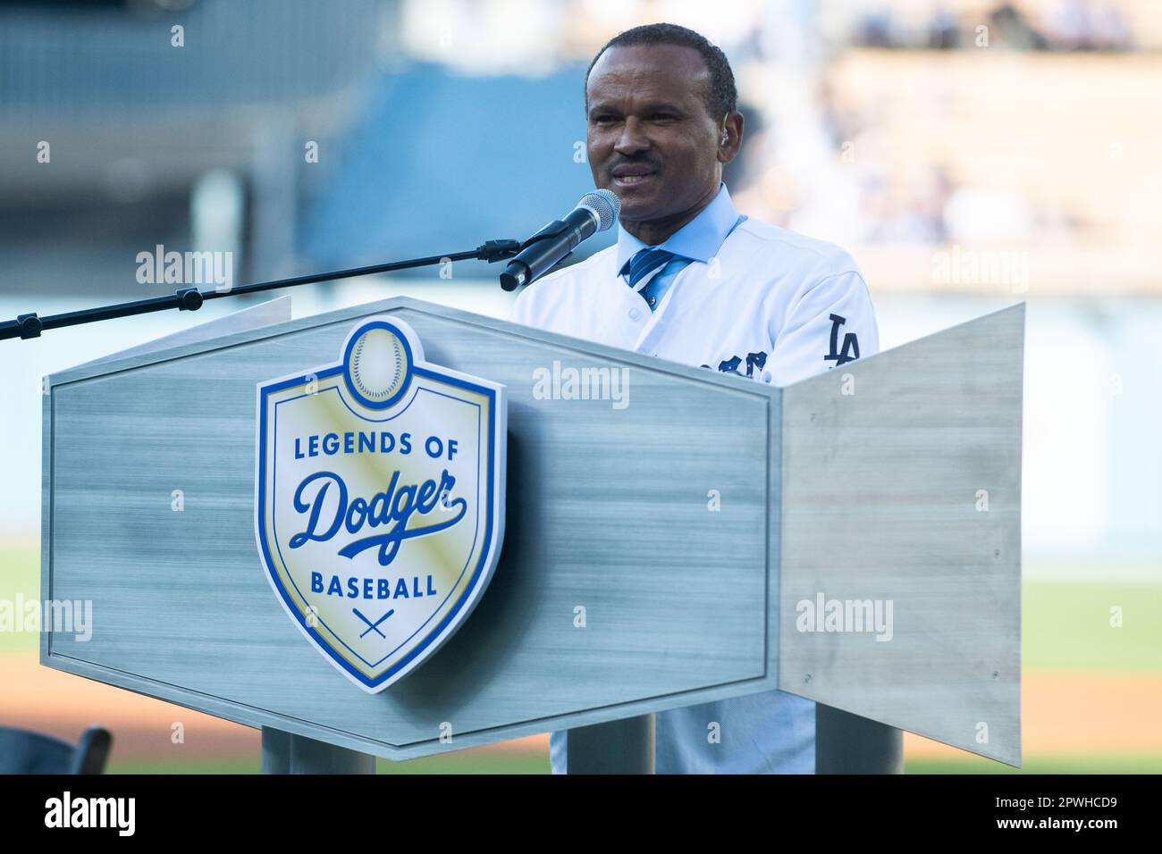 Former Los Angeles Dodger Manny Mota, left, gets a hug from his son Jose as  he is inducted into the Legends of Dodger Baseball prior a baseball game  between the Dodgers and