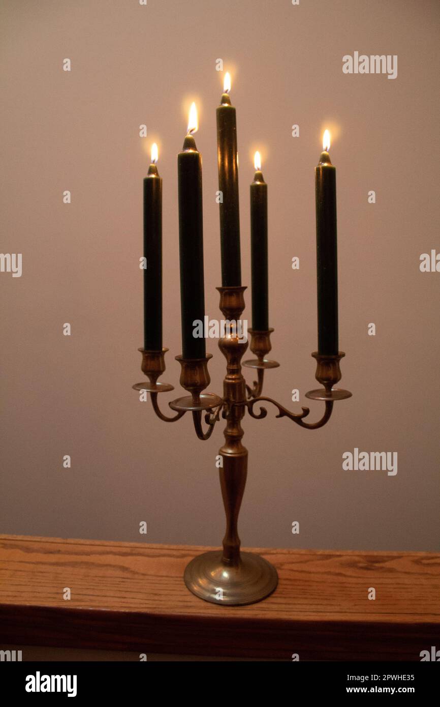 Lit candles in a candelabra Stock Photo Alamy