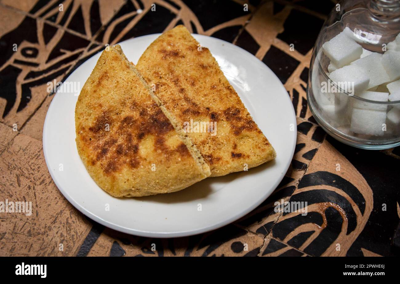 Traditional Moroccan breakfast bread and sugar placed on dining table Stock Photo