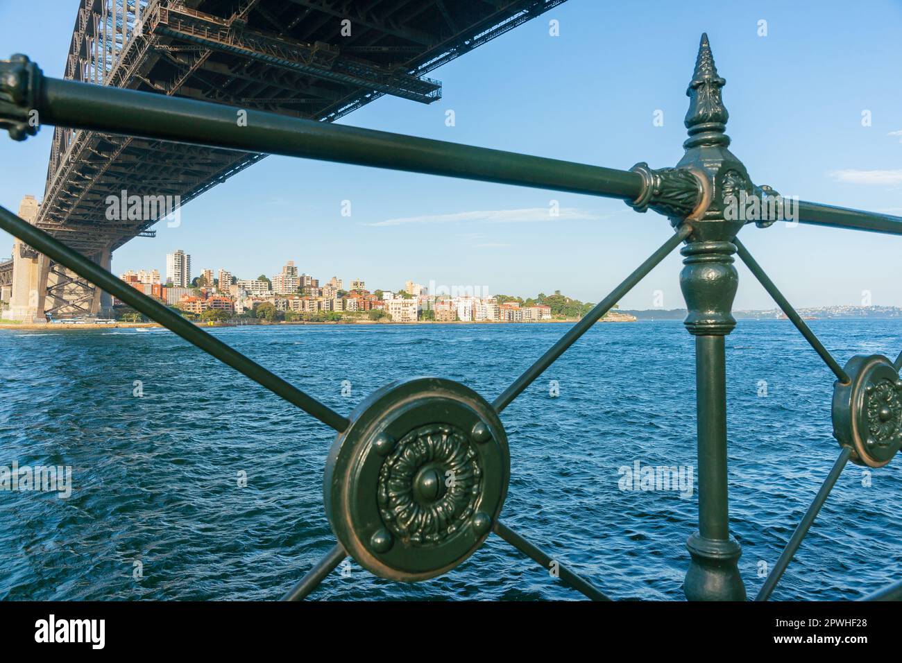 View through green wrought iron railing under Sydney Harbour Bridge ...