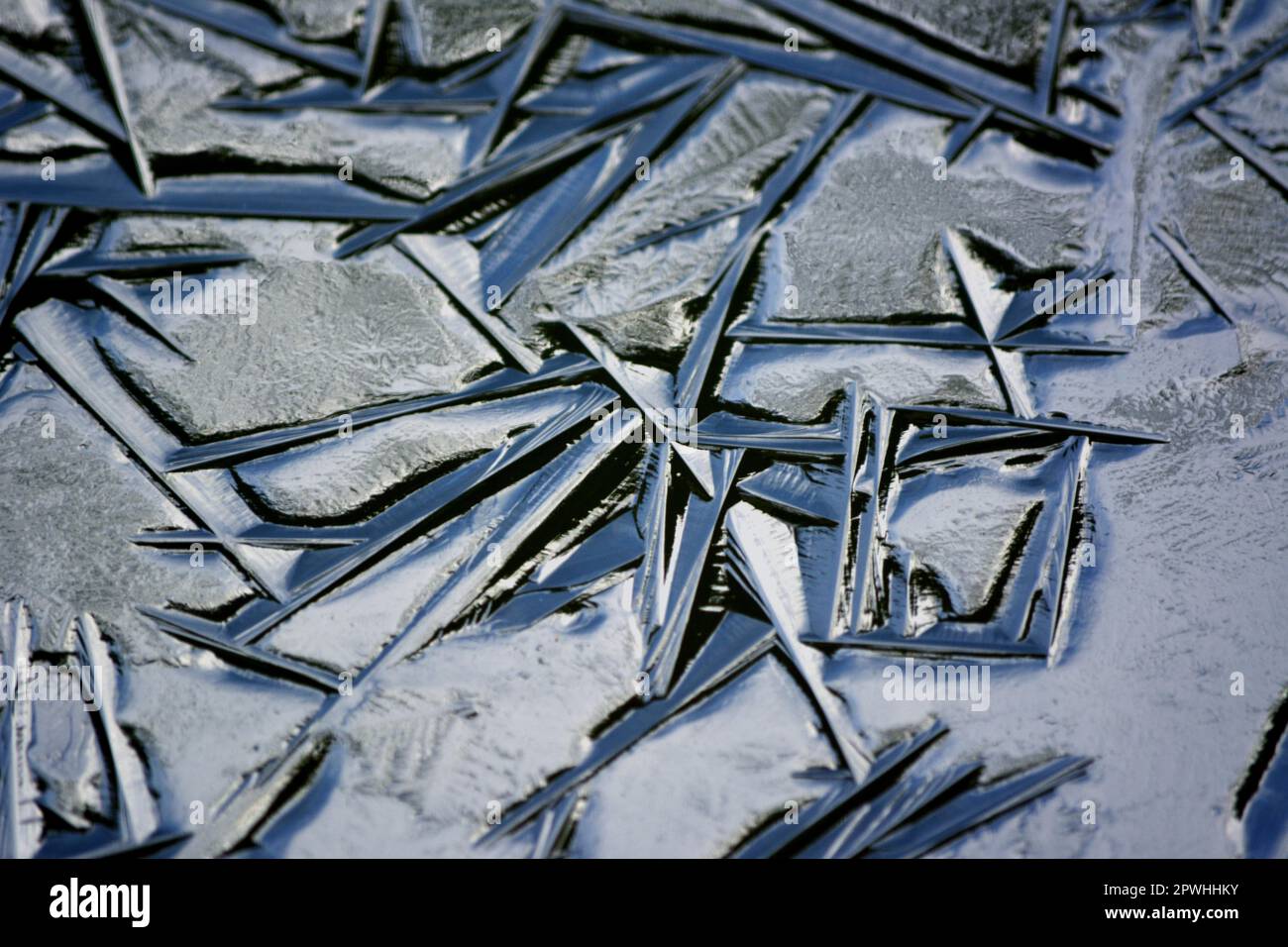 Frozen garden pond in winter, ice structures, ice formations Stock Photo