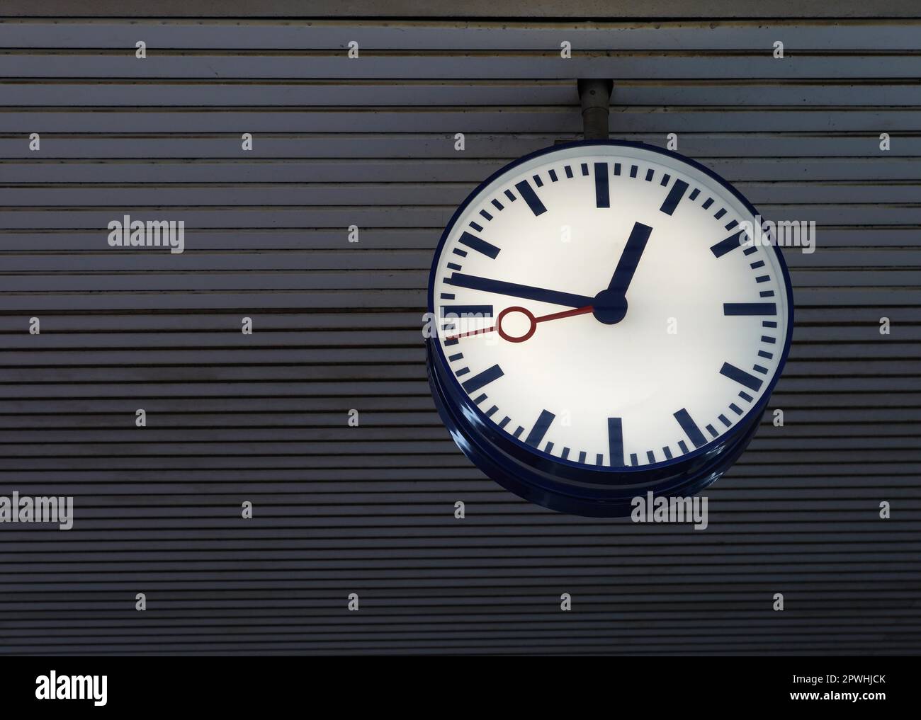 station clock hanging from ceiling. illuminated clock face without numbers Stock Photo Alamy