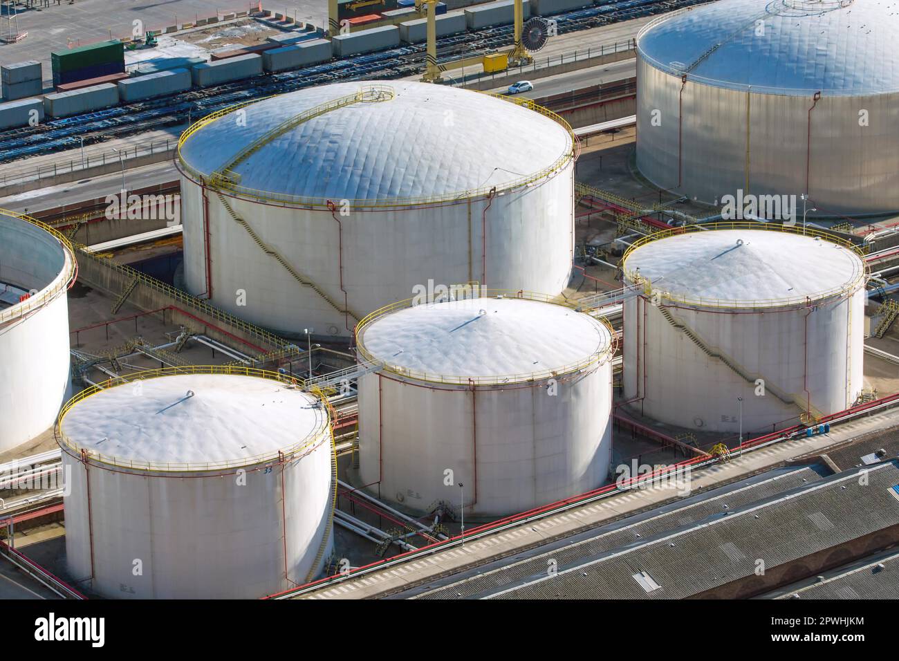 White gas tanks in an industrial area at the harbour Stock Photo