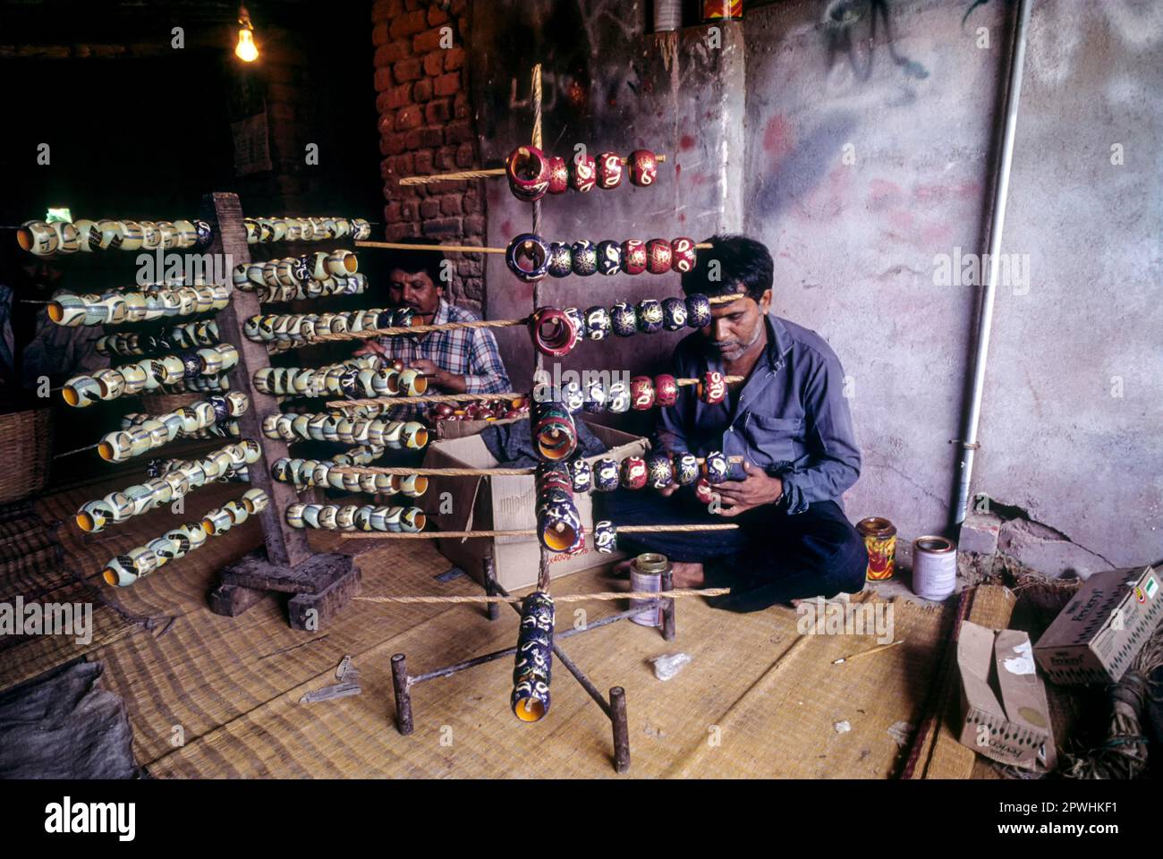 Painting a wooden toy at Channapatna a flourishing centre for