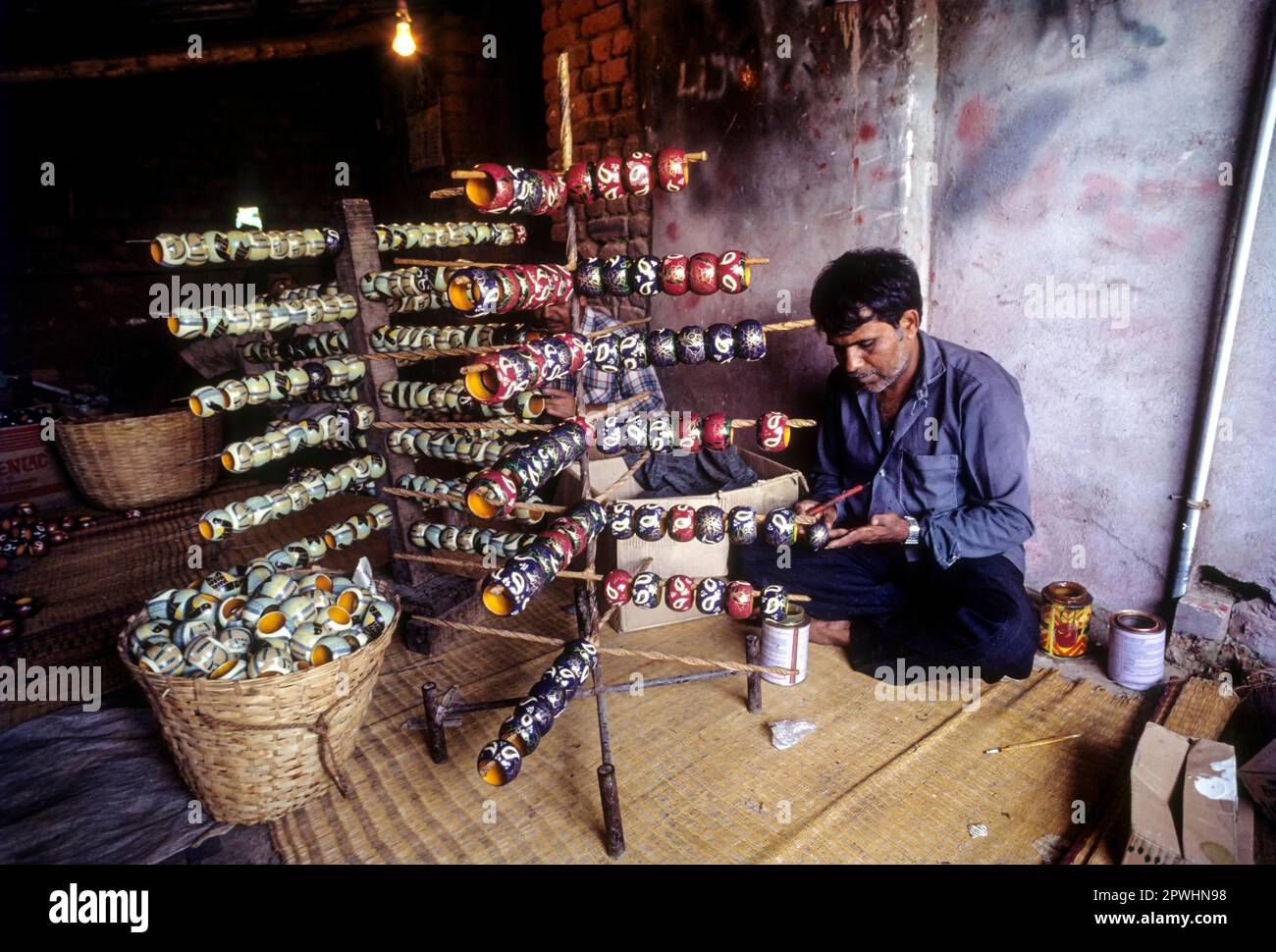 Painting a wooden toy at Channapatna a flourishing centre for