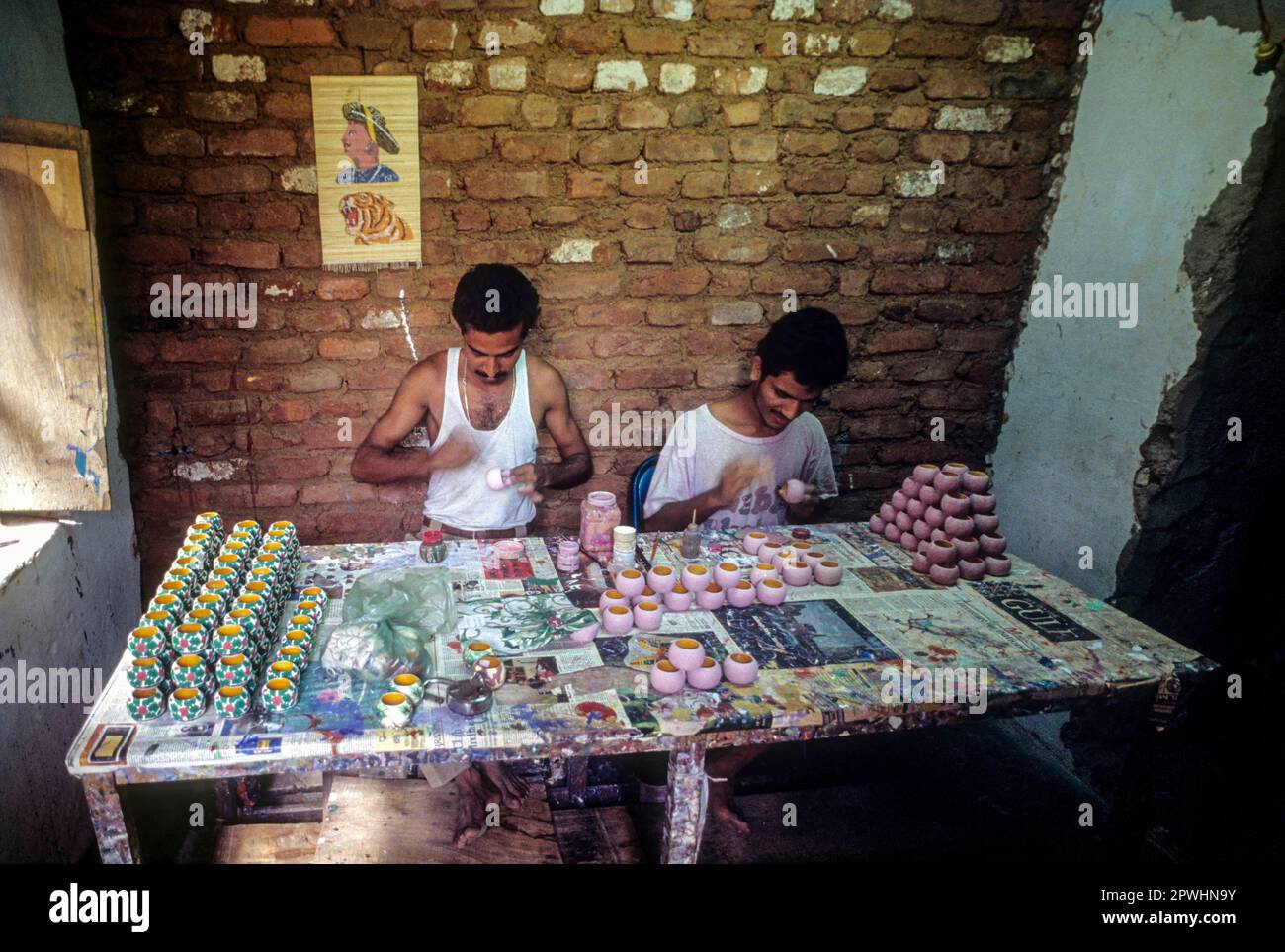 Painting a wooden toy at Channapatna a flourishing centre for