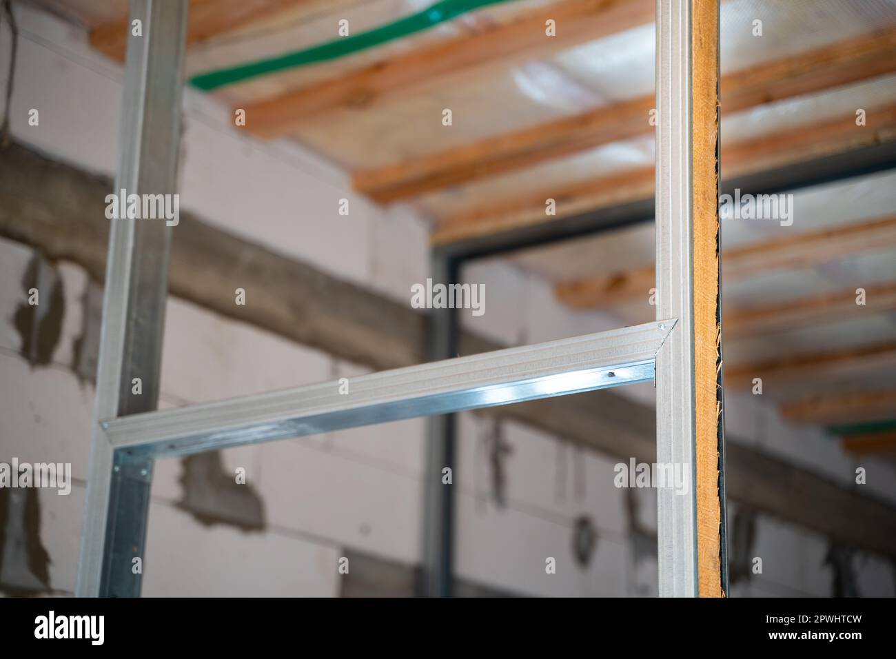 Strengthening the strength and solidity of the metal profile frame with a wooden beam in the place of the doorway. Construction of a metal profile for Stock Photo
